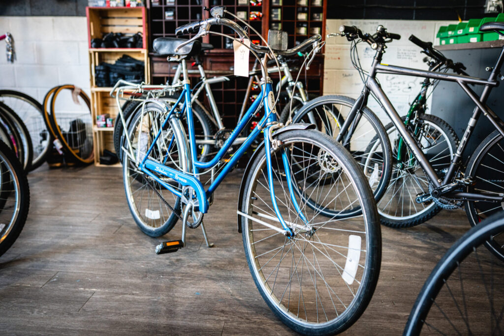 A blue bike with thin tires and no cross bar.