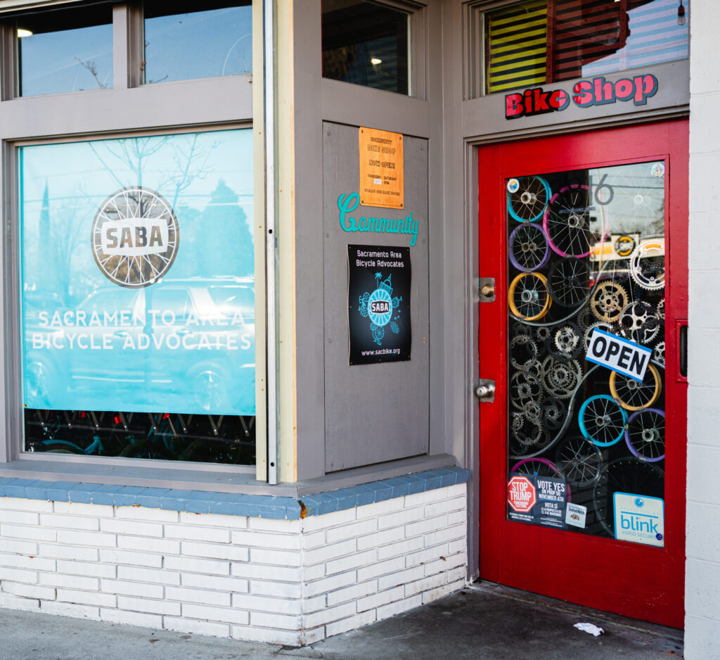Storefront with a SABA sign and a red trimmed glass door.